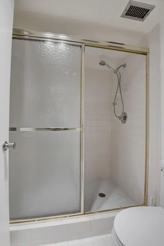 a bathroom with a glass shower door