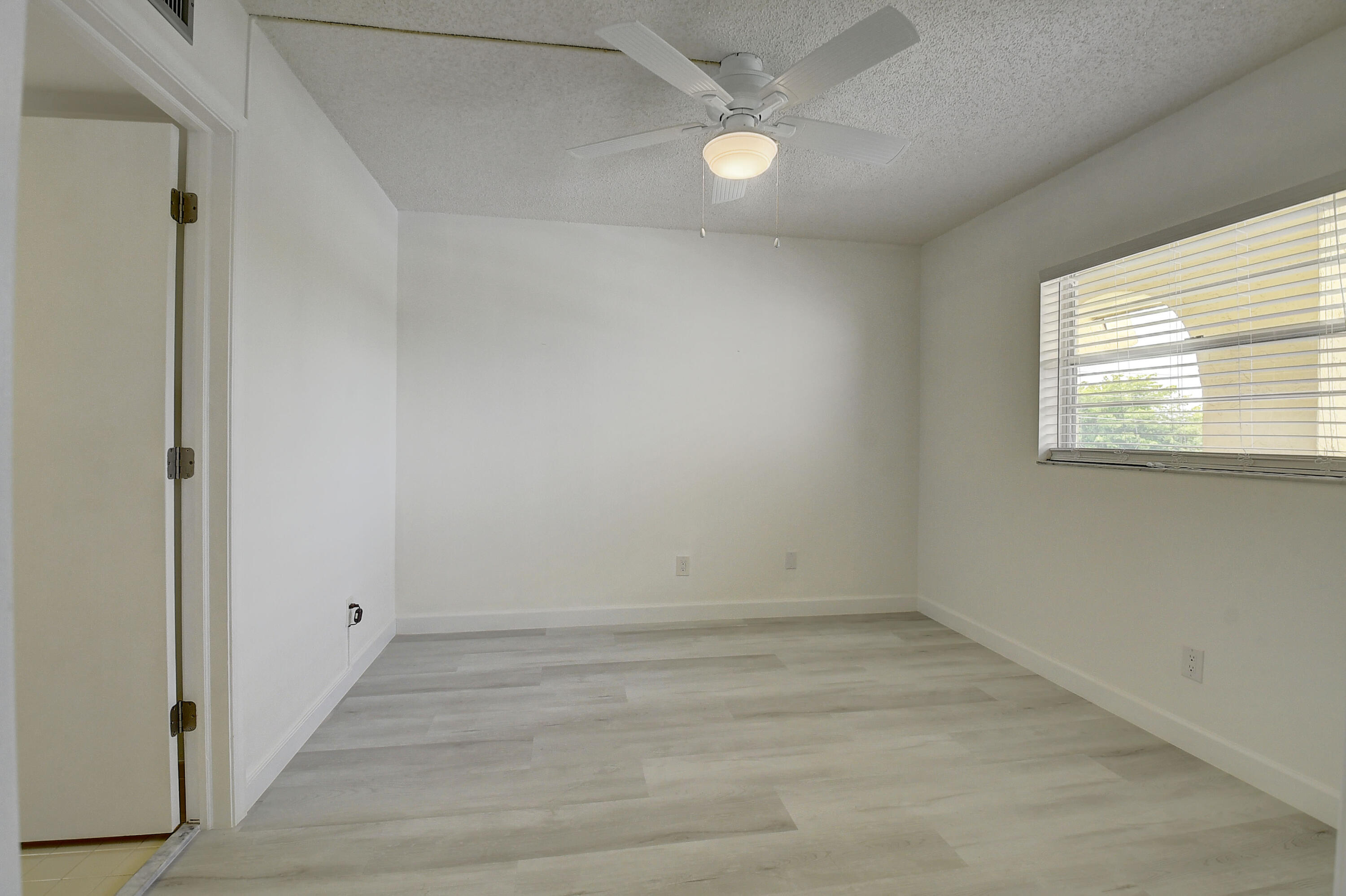 23305 Barwood Lane North, Unit 406 Boca Raton, FL 33428 - Photo 22 of 41 an empty room with a window