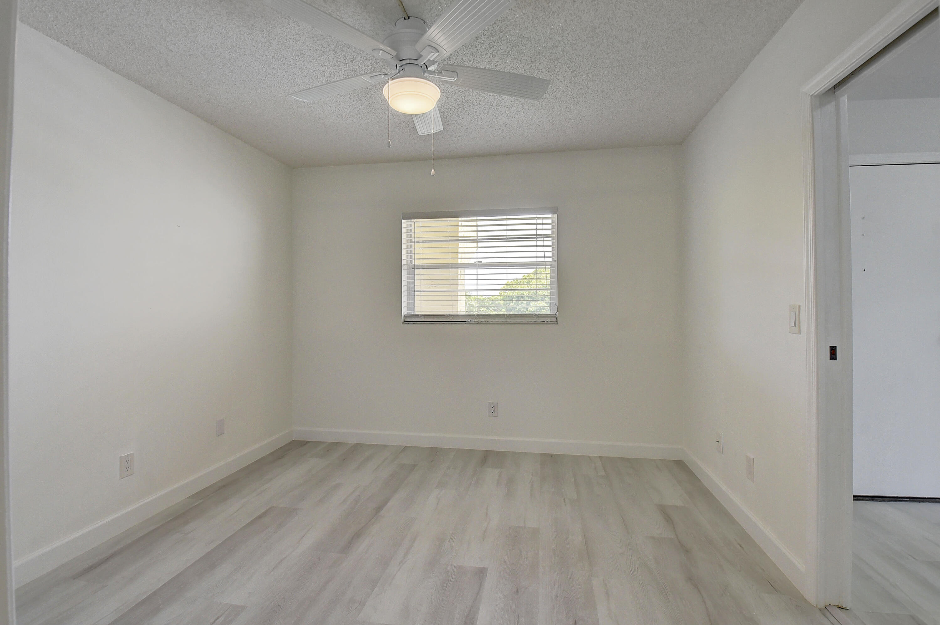 23305 Barwood Lane North, Unit 406 Boca Raton, FL 33428 - Photo 24 of 41 an empty room with a window