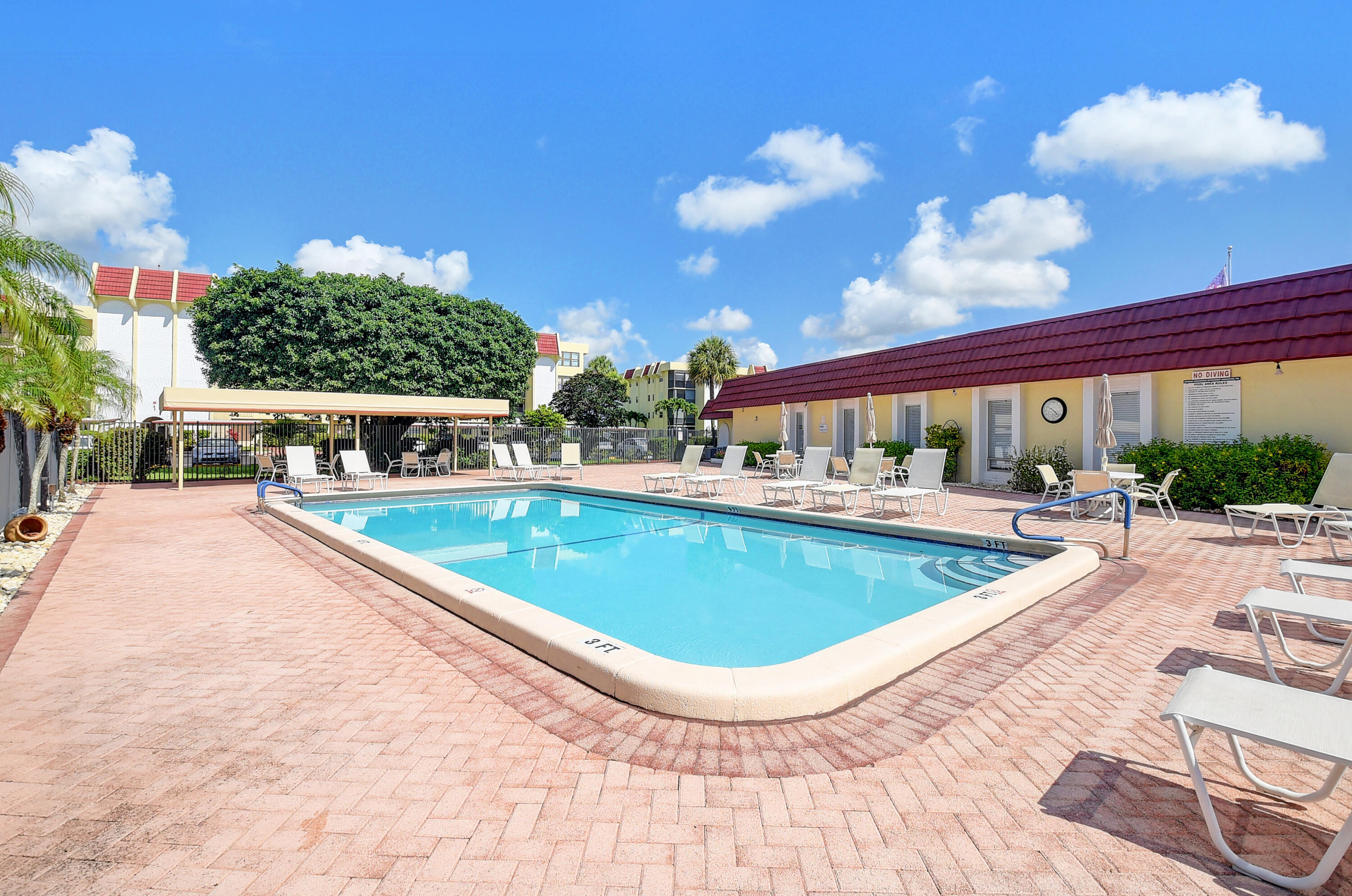 23305 Barwood Lane North, Unit 406 Boca Raton, FL 33428 - Photo 31 of 41 a view of a swimming pool with outdoor seating