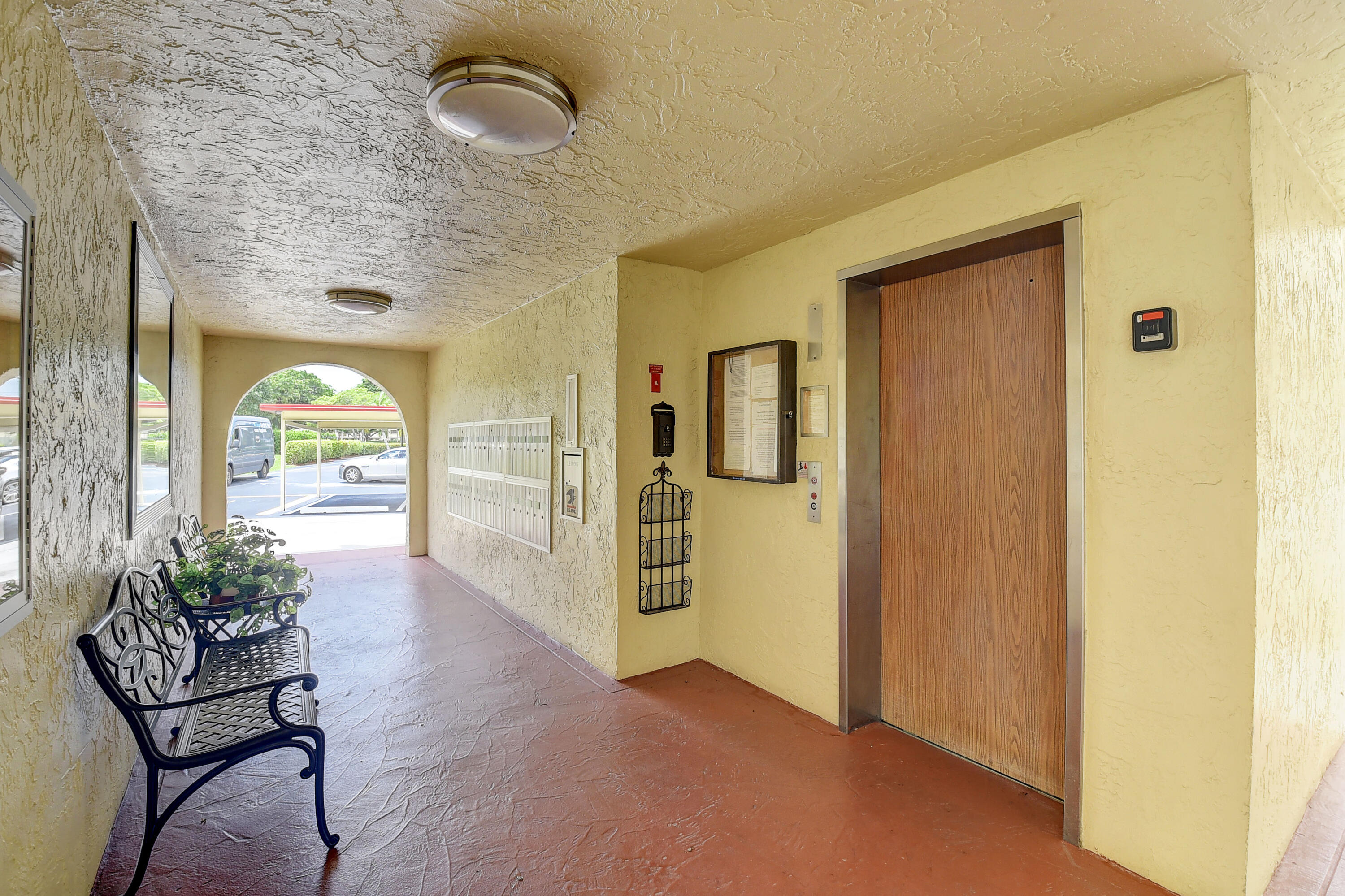 23305 Barwood Lane North, Unit 406 Boca Raton, FL 33428 - Photo 40 of 41 a view of a hallway with furniture and a window