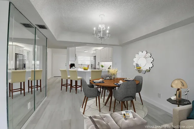 a view of a dining room with furniture and chandelier