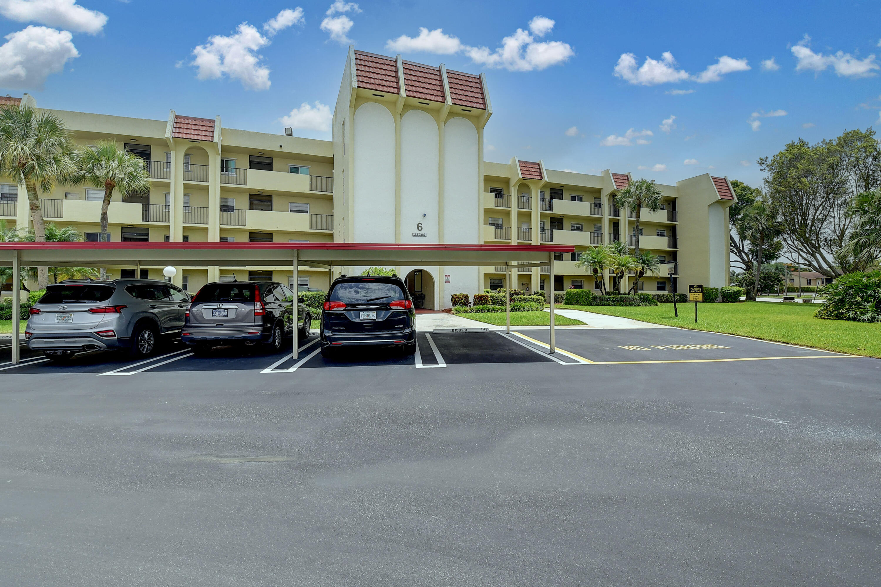 23305 Barwood Lane North, Unit 406 Boca Raton, FL 33428 - Photo 41 of 41 a couple of cars parked in front of a building