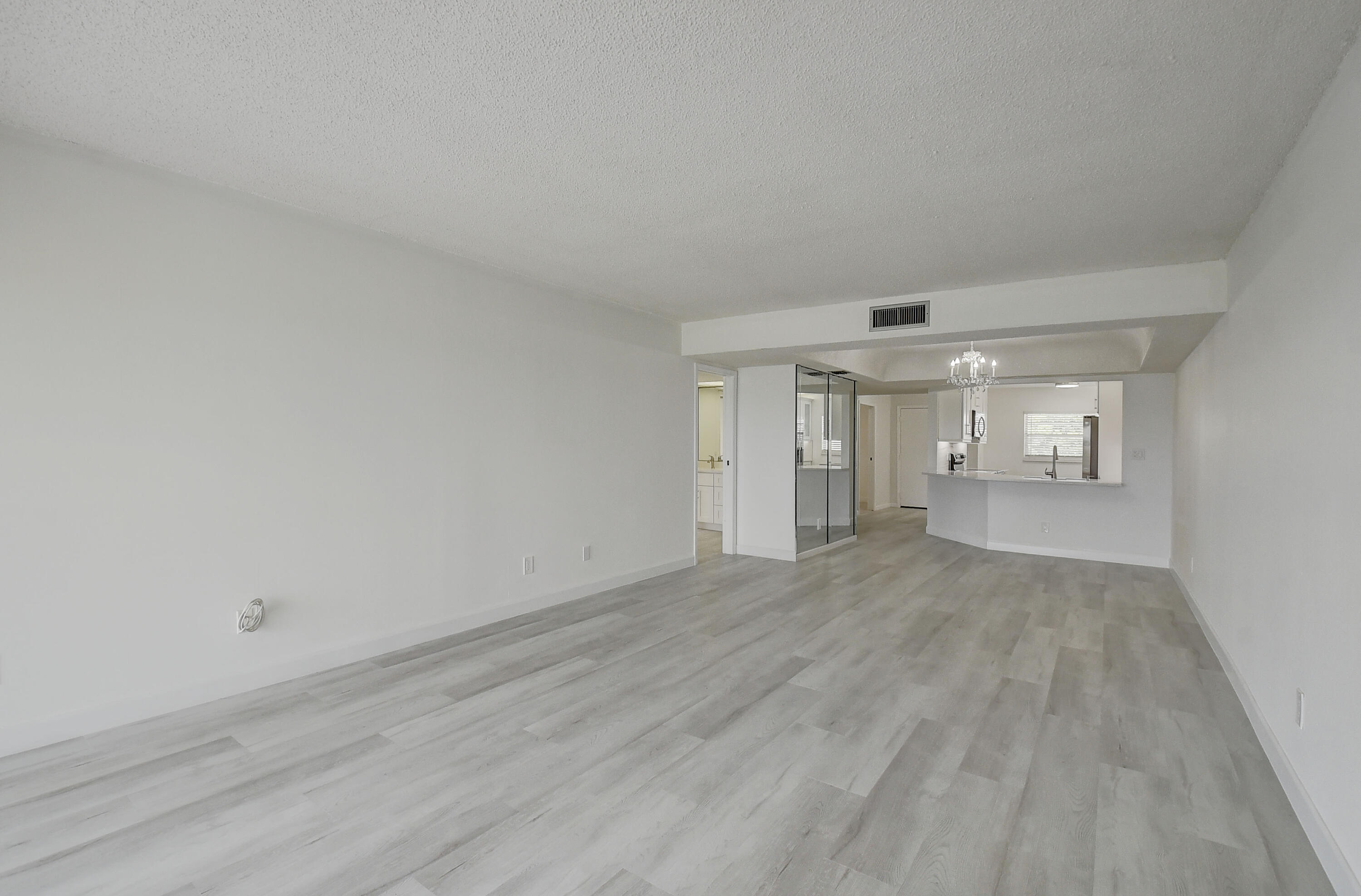 23305 Barwood Lane North, Unit 406 Boca Raton, FL 33428 - Photo 5 of 41 a view of empty room with wooden floor