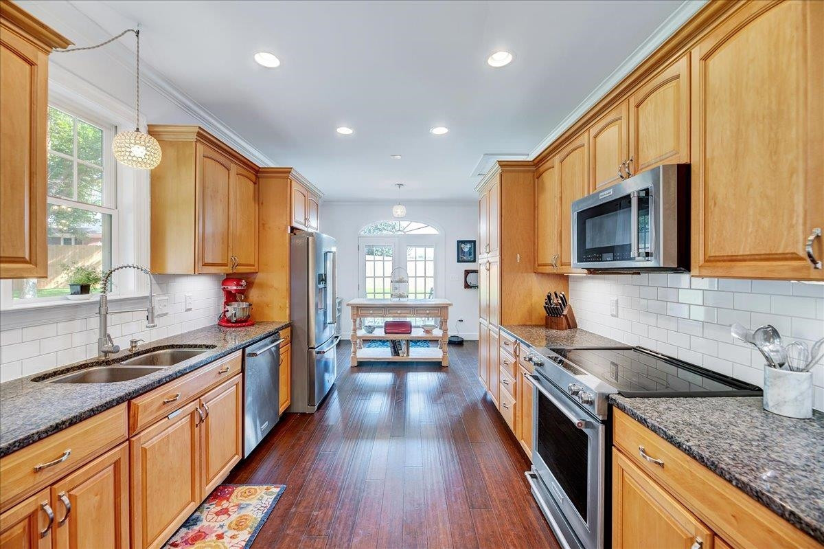 2222 Zacks Mill Road Angier, NC 27501 - Photo 24 of 48 a large kitchen with stainless steel appliances granite countertop a lot of counter space and wooden floors
