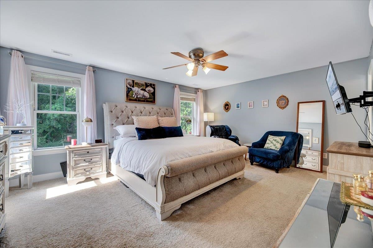 2222 Zacks Mill Road Angier, NC 27501 - Photo 31 of 48 a bedroom with a bed and a chandelier