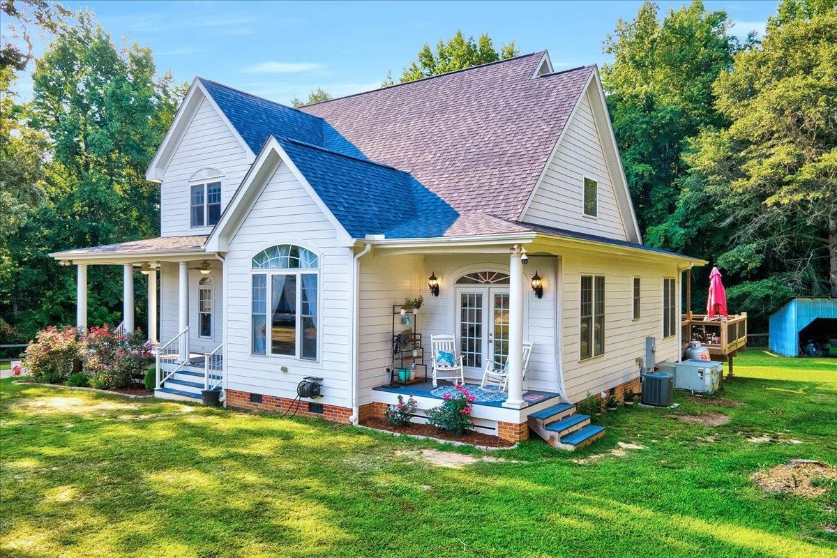 2222 Zacks Mill Road Angier, NC 27501 - Photo 4 of 48 a view of a house with backyard sitting area and garden