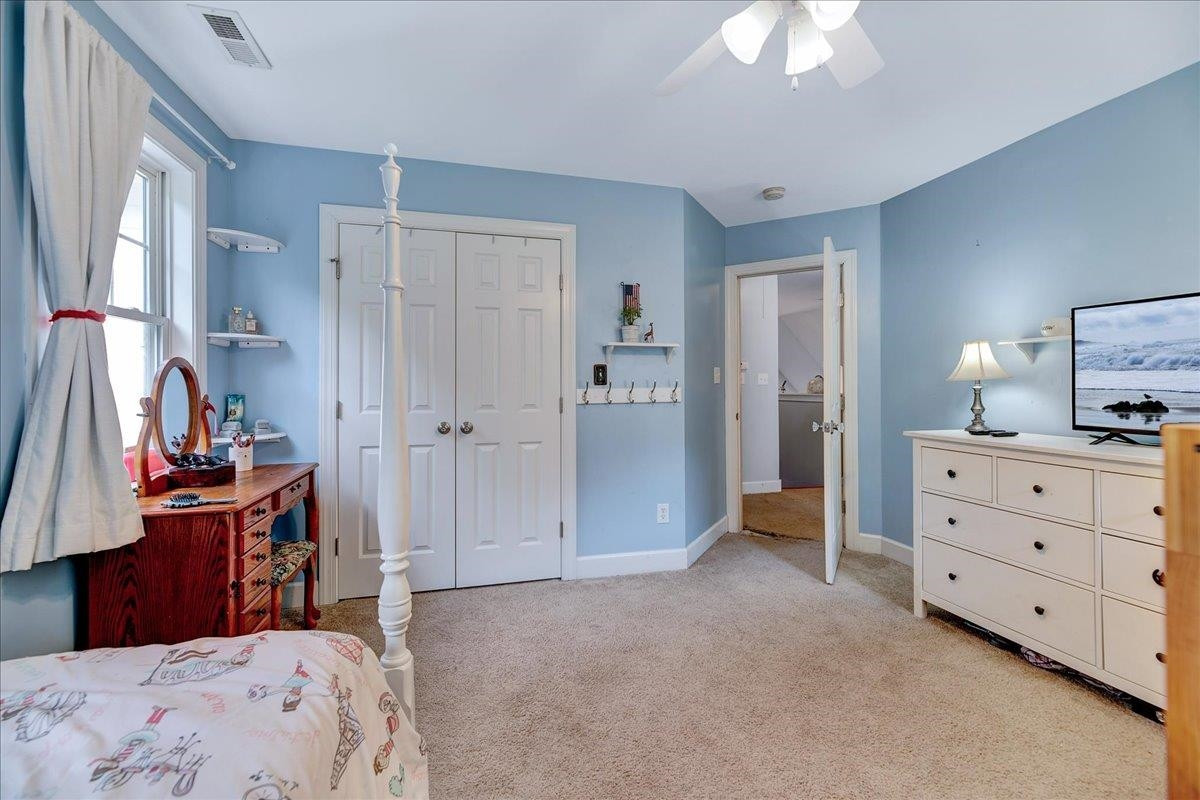 2222 Zacks Mill Road Angier, NC 27501 - Photo 41 of 48 a bedroom with a bed and a chandelier