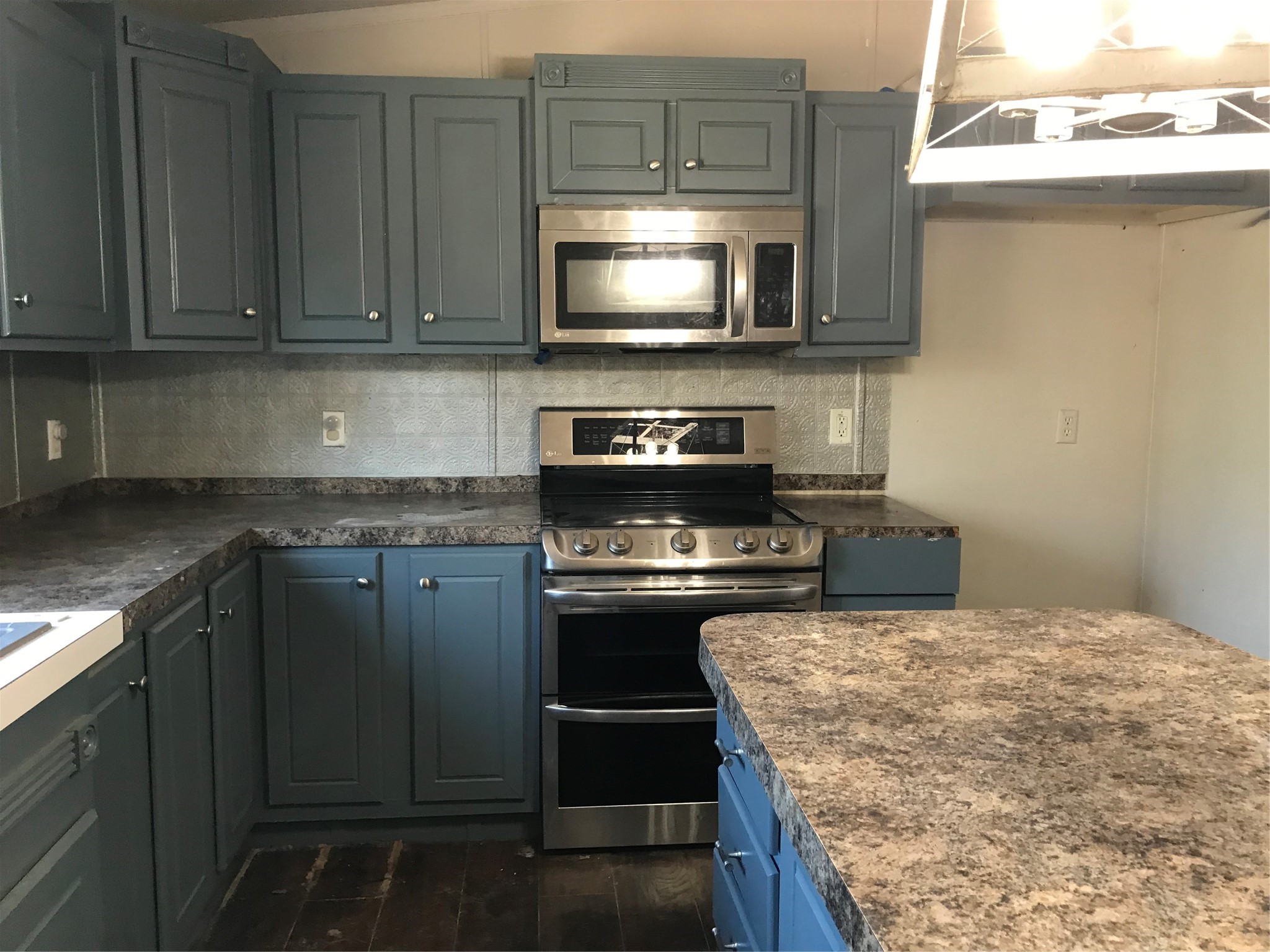 31606 Bryan Street Magnolia, TX 77355 - Photo 2 of 19 a kitchen with stainless steel appliances granite countertop a stove top oven microwave and cabinets