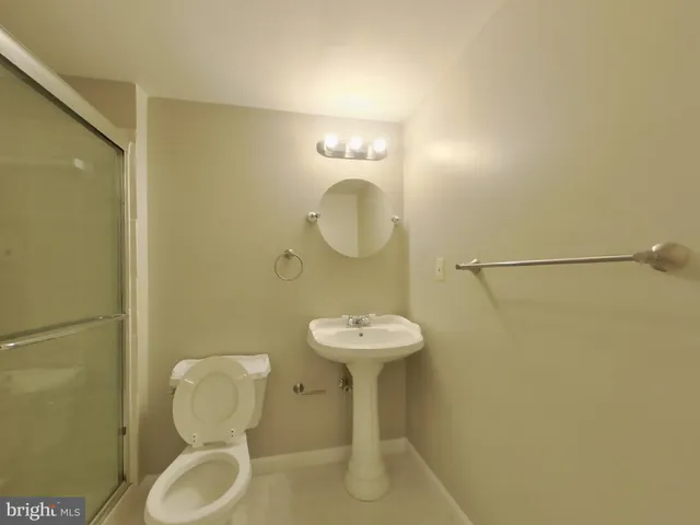 a bathroom with a sink mirror and toilet
