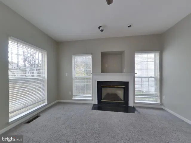 a view of empty room with a fireplace