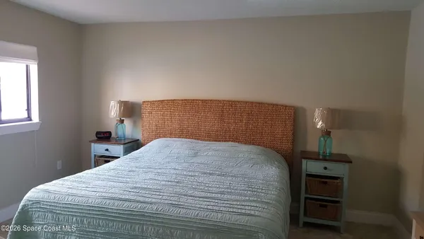 a bedroom with a bed and a night stand