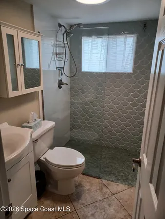 a bathroom with a toilet and a shower
