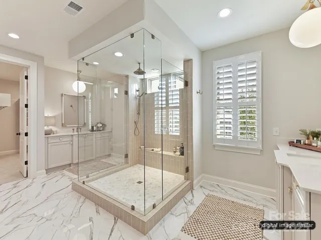 a bathroom with a glass shower door and a sink