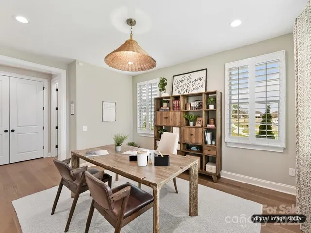 a view of a bedroom with furniture and wooden floor