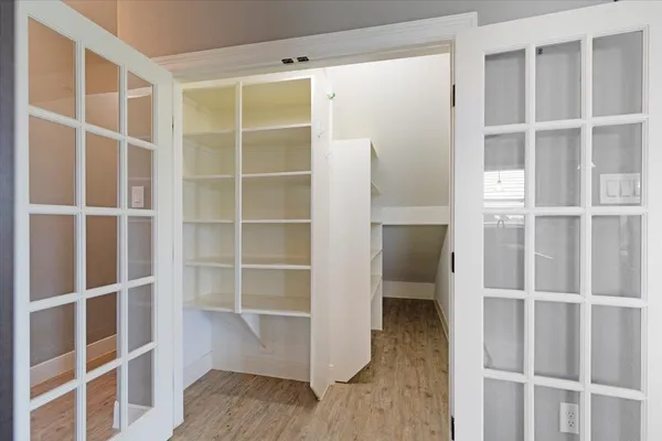 a view of walk in closet with empty racks