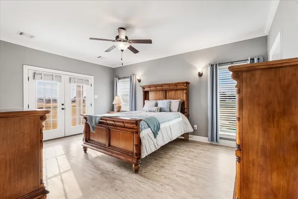 a spacious bedroom with a bed and a chandelier