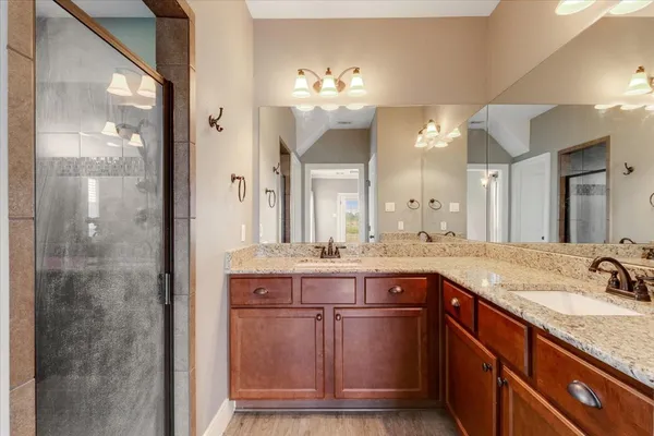 a bathroom with a sink double vanity and a mirror
