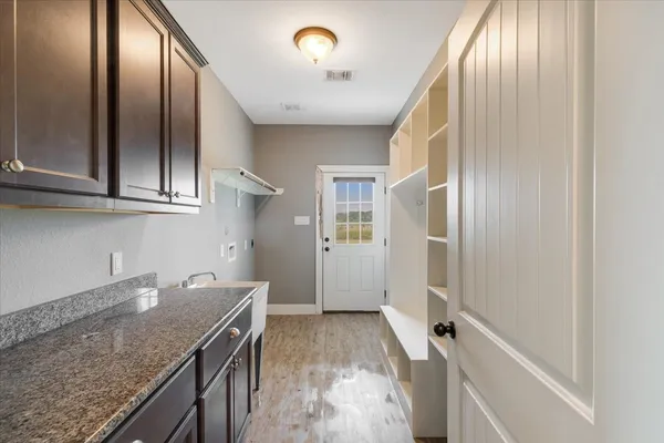 a view of a kitchen with granite countertop cabinets