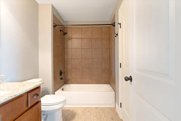 a bathroom with a toilet a sink and bathtub