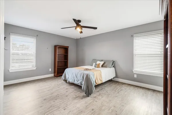 a spacious bedroom with a bed and a large window