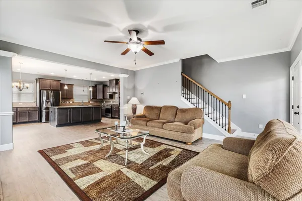 a living room with furniture and kitchen view