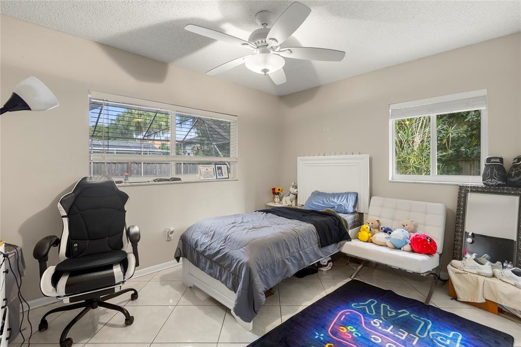 10344 Dorchester Drive Boca Raton, FL 33428 - Photo 16 of 30 a bedroom with a bed and wooden floor