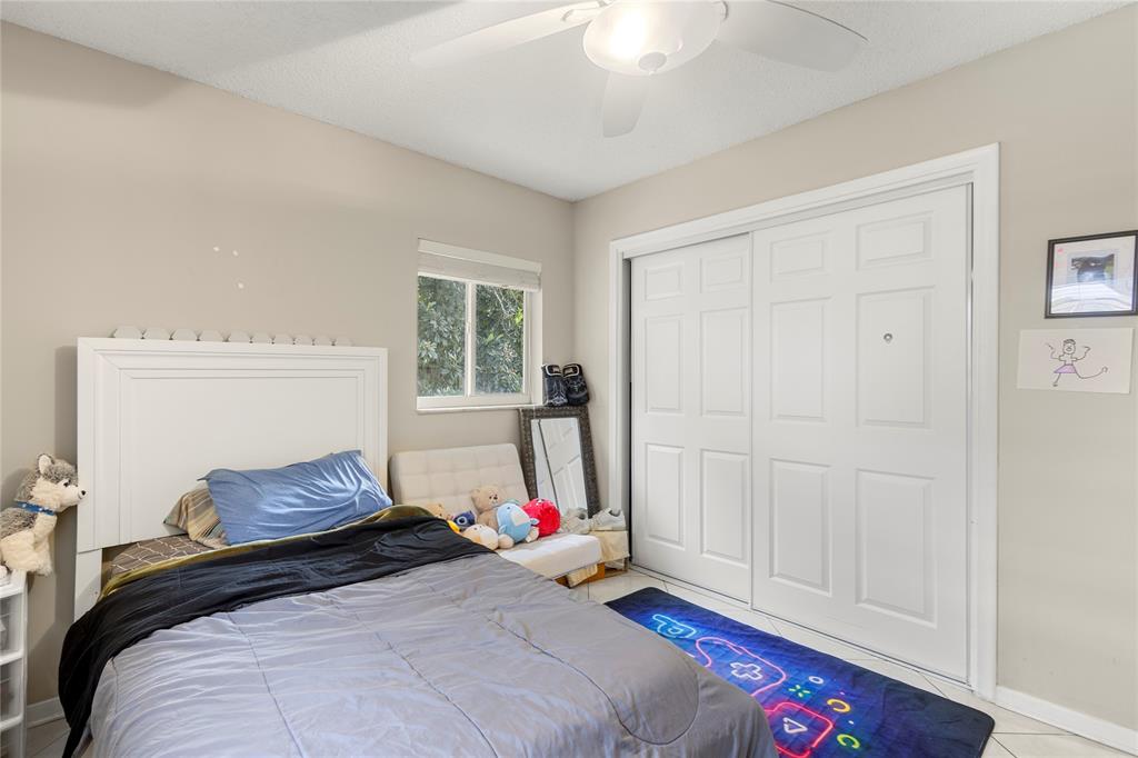 10344 Dorchester Drive Boca Raton, FL 33428 - Photo 17 of 30 a bedroom with a bed and a window