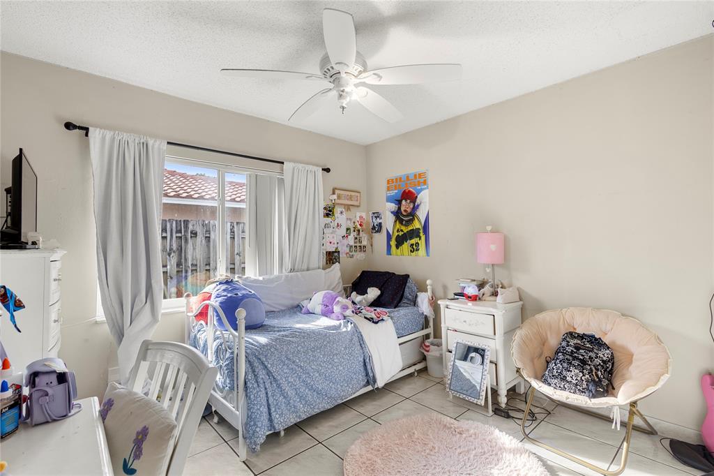 10344 Dorchester Drive Boca Raton, FL 33428 - Photo 19 of 30 a bedroom with a bed and a window