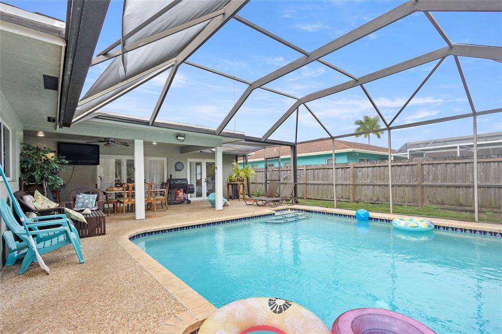 10344 Dorchester Drive Boca Raton, FL 33428 - Photo 25 of 30 a swimming pool with outdoor seating and yard