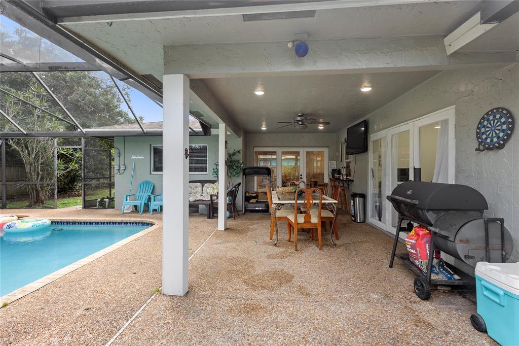 10344 Dorchester Drive Boca Raton, FL 33428 - Photo 28 of 30 a living room with furniture a pool table and a fireplace
