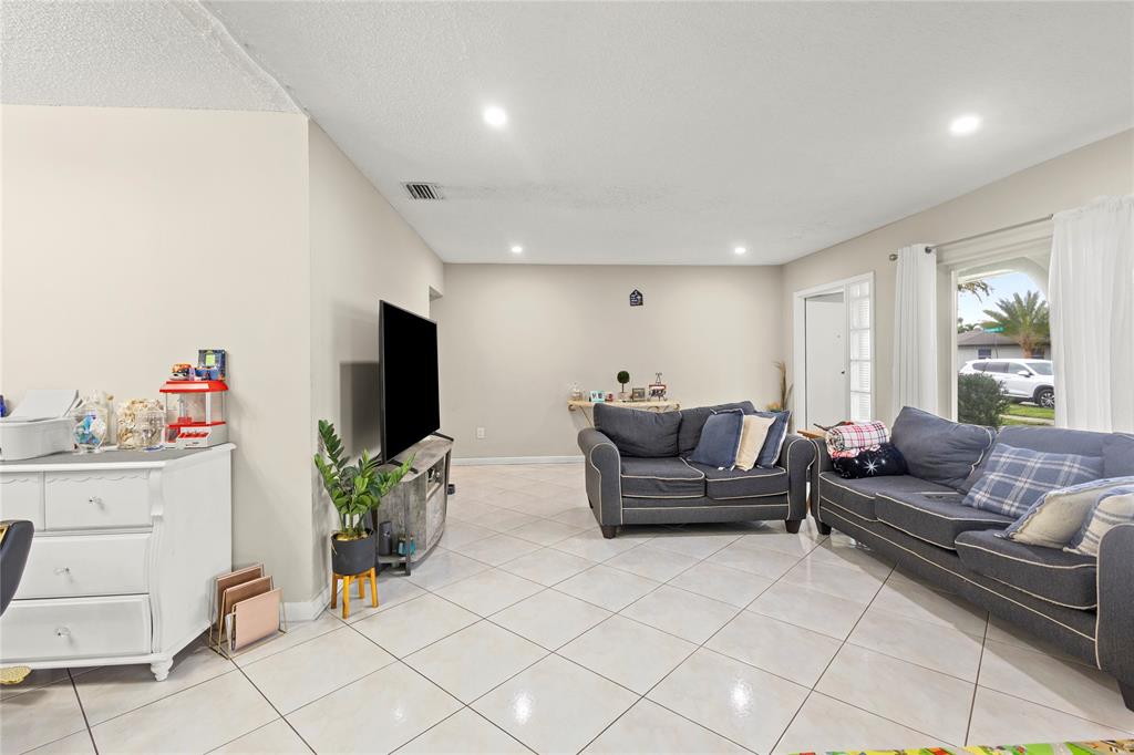 10344 Dorchester Drive Boca Raton, FL 33428 - Photo 4 of 30 a living room with furniture and a flat screen tv