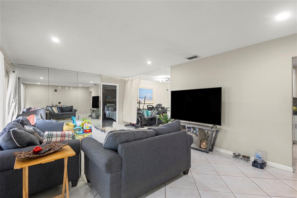 10344 Dorchester Drive Boca Raton, FL 33428 - Photo 5 of 30 a living room with furniture and a flat screen tv
