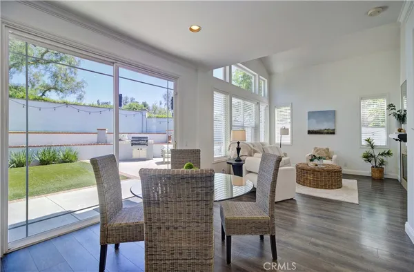 a dining room with furniture window and wooden floor