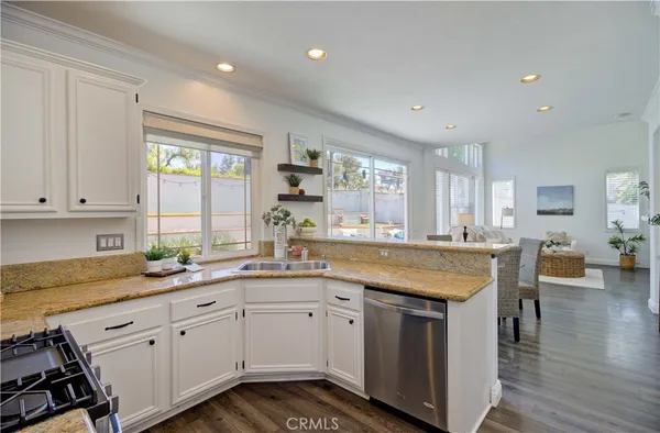 a kitchen with a sink stove and cabinets