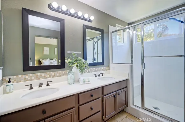 a bathroom with double vanity sink and a mirror