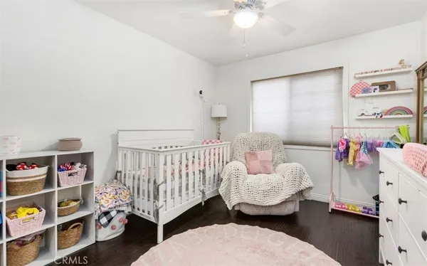 a bedroom with furniture and a baby crib