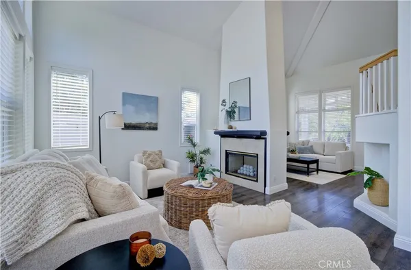 a living room with furniture a fireplace and window