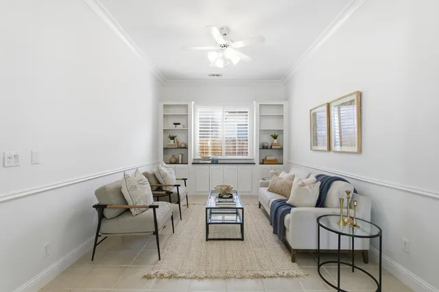 a spacious bedroom with a bed and a chandelier