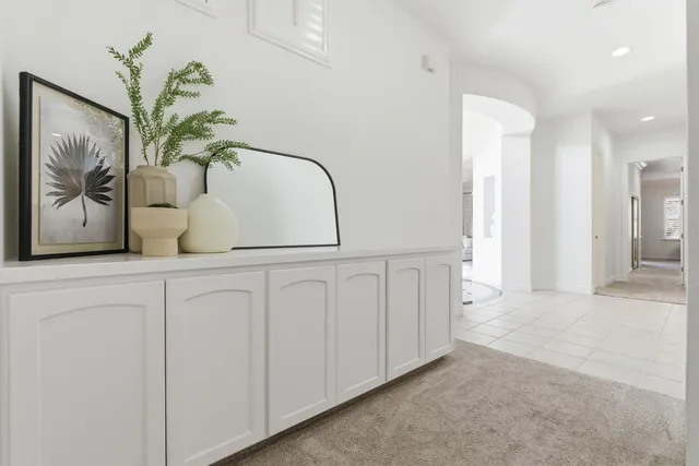 a spacious bedroom with a bed a couch and potted plant