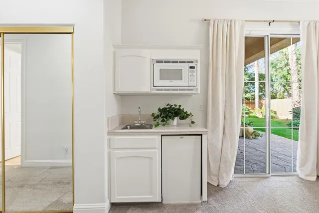 a view of a room with wooden floor and windows