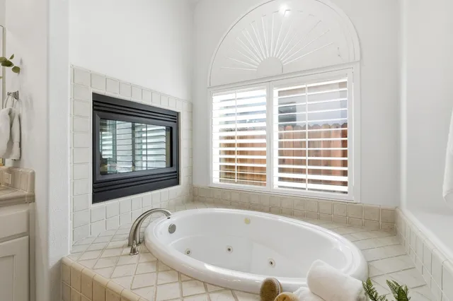 a bed room with a bed a desk and a chandelier