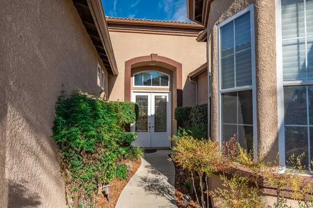 an entryway with a flower pot and a potted plant