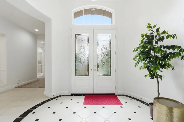 a bedroom with a bed and a potted plant