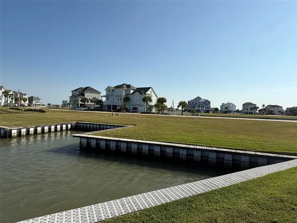 a view of a lake with houses in the back