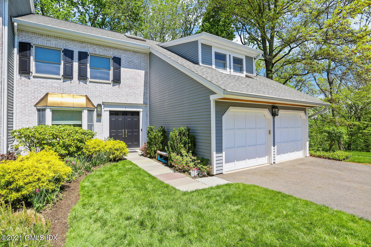 1 Old Church Road, Unit 7 Greenwich, CT 06830 - Photo 1 of 42 a front view of a house with a garden and yard