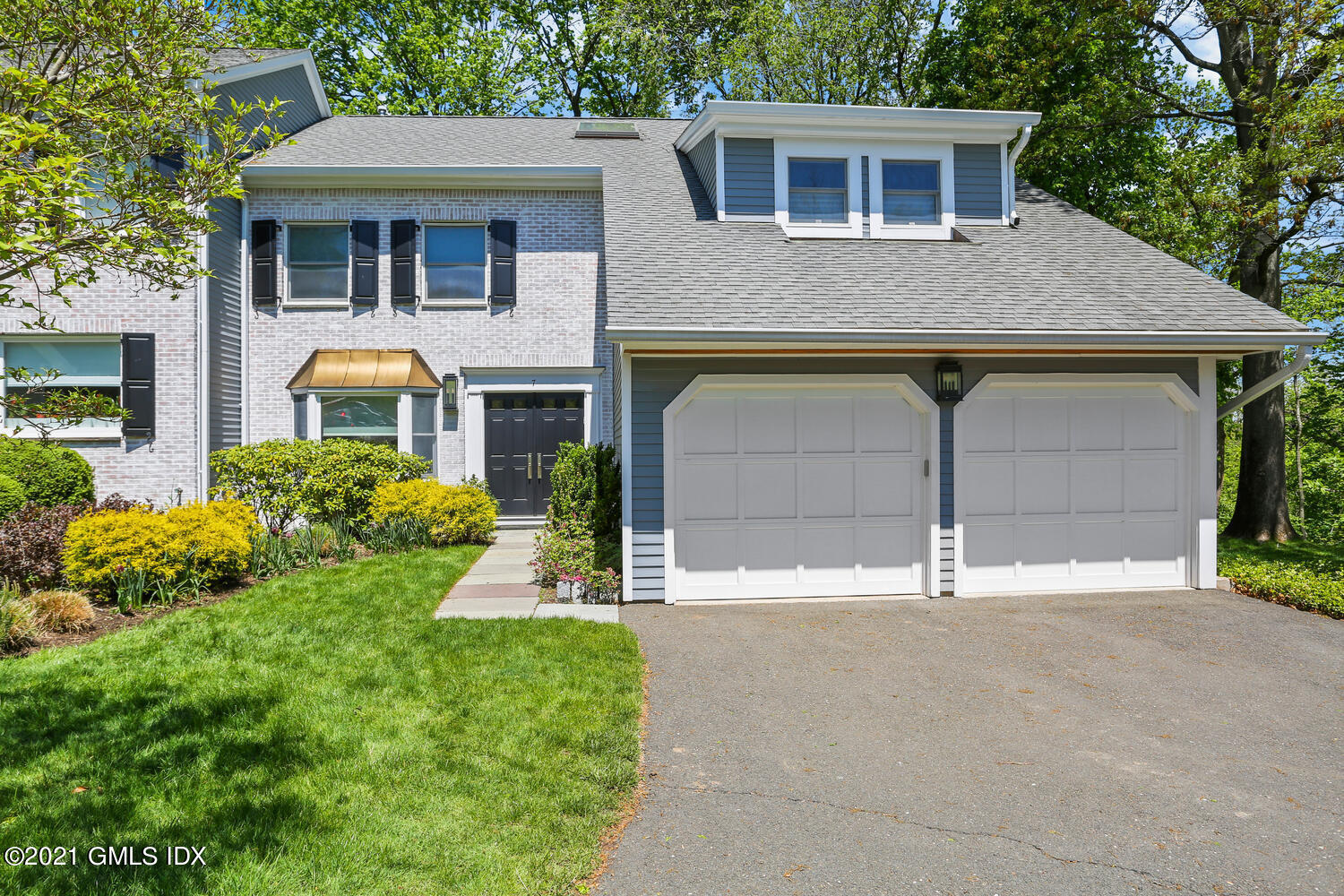 1 Old Church Road, Unit 7 Greenwich, CT 06830 - Photo 2 of 42 a front view of a house with a yard and garage