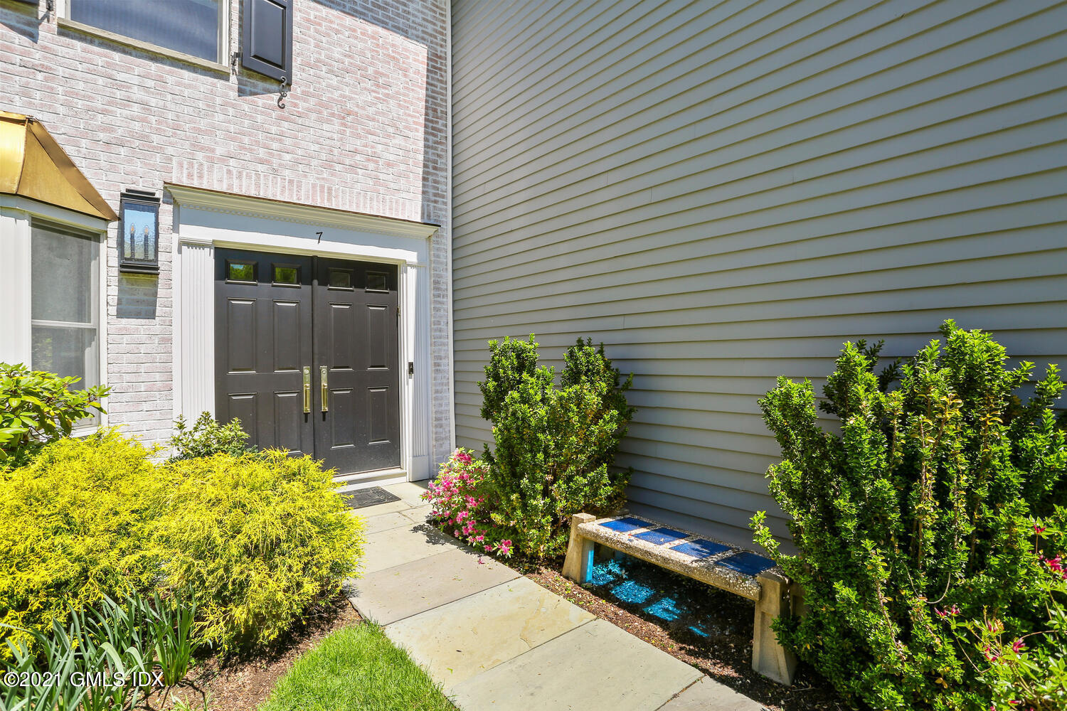1 Old Church Road, Unit 7 Greenwich, CT 06830 - Photo 3 of 42 a front view of a house with a garden