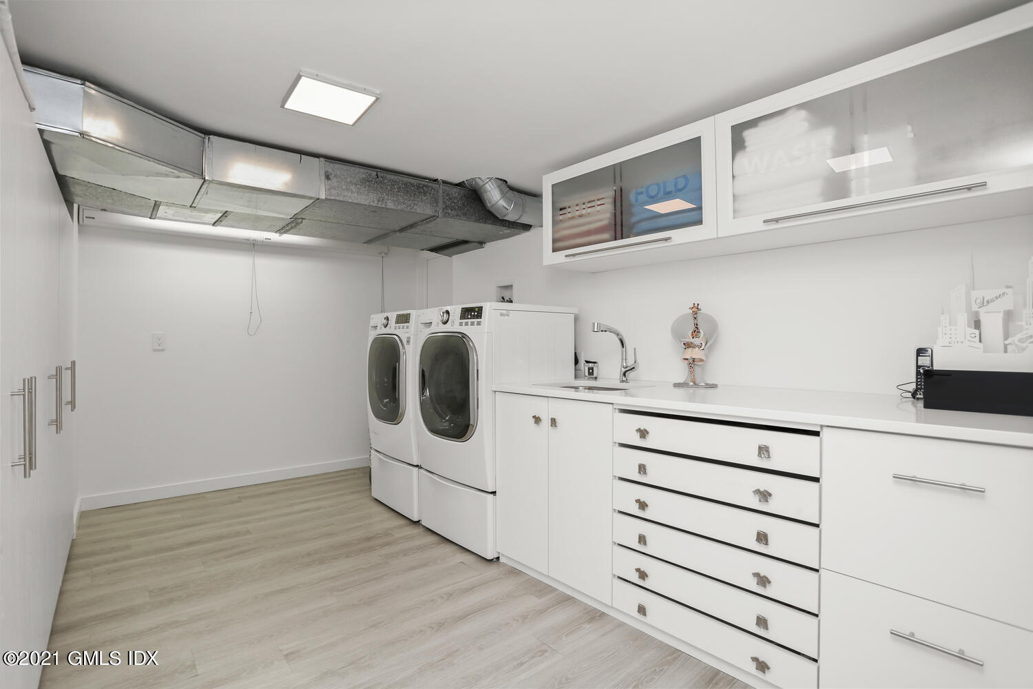 1 Old Church Road, Unit 7 Greenwich, CT 06830 - Photo 33 of 42 a white kitchen with white cabinets and white appliances
