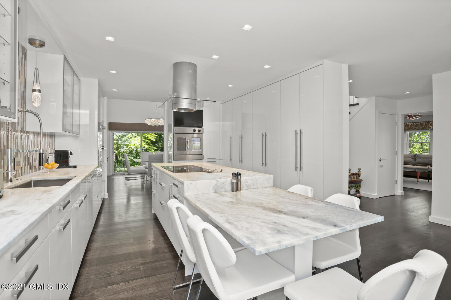 1 Old Church Road, Unit 7 Greenwich, CT 06830 - Photo 9 of 42 a large kitchen with kitchen island a sink table and chairs